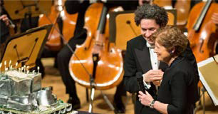 Deborah Borda LA Phil CEO가 지휘자 Gustavo Dudamel의 36번째 생일을 맞아연주회 직후 무대에서 Disney Concert Hall 모습의 생일 케이크를 선물하고 있다.