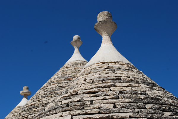 Alberobello - Carved stone pinnacles atop refurbished trullo cones