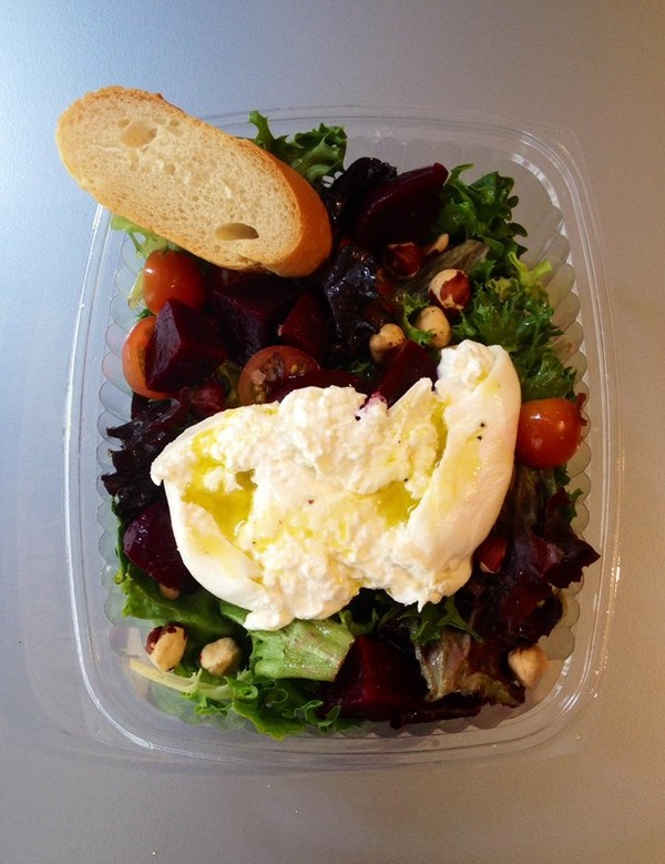 Burrata cheese on a salad with Coratina extraverigin Olive oil