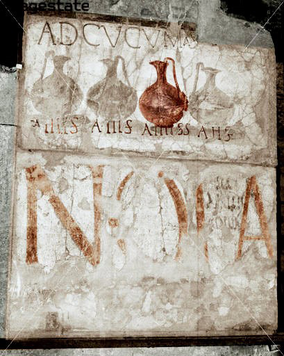 Sign of a Roman-era tavern, “Ad Cucumas”, (“jugs” in Latin). Every jug of wine with prices below. Herculaneum, nearby Pompeii, Italy.