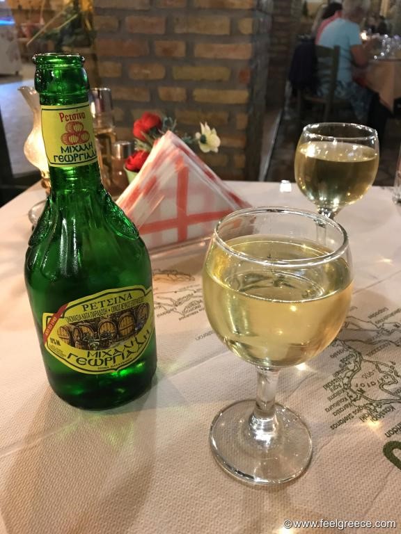 bottle of Retsina wine. The name of the winemaker, Michalis Georgiades, written in Greek