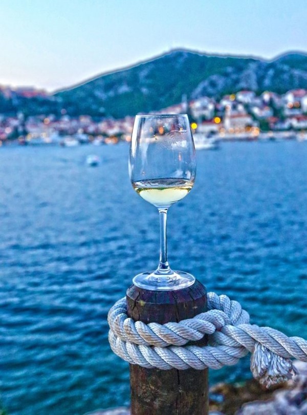 A glass of white Kaštelet bijeli wine in Hvar Island, Croatia