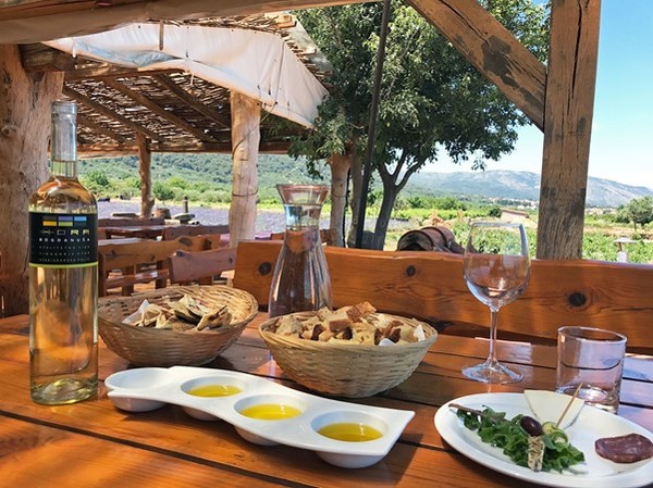 Bogdanuša white wine, bread, olive oil, salami and cheese. Hvar Island, Croatia
