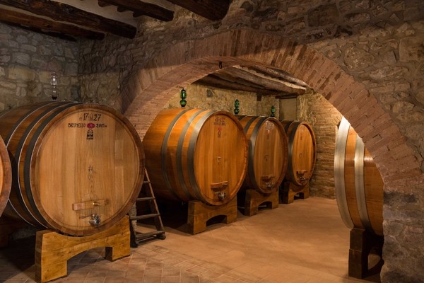 Oak Barrels of Brunello di Montalcino in a winery. Montalcino, Italy. Photo credits: www.verdidea.com