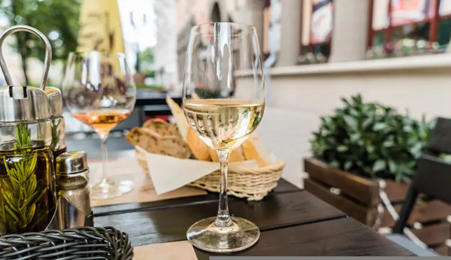 A glass of Etna Bianco with bread and olive oil. Photo Credits www.winedharma.com
