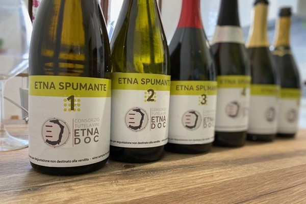 Bottles of Etna Spumante (dry or brut sparkling wine). Photo Credits www.aislombardia.it