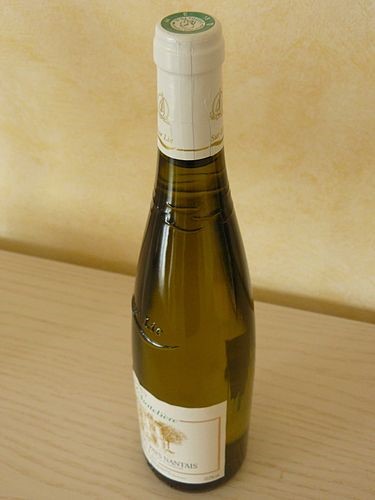 A bottle of Gros-plant-du-Pays-Nantais, another AOC white wine from the French region of Pays de la Loire. Made from Folle-blanch grapes, it has a dry and fresh taste, a pale color with greenish hues, floral aromas of white f