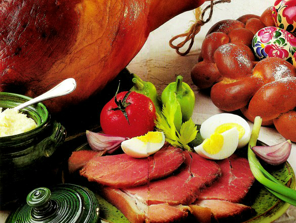 Traditional Easter dishes: Smoked ham (sonka), hard-boiled eggs, braided Easter bread (kalács), and fresh horseradish (Its Hungarian)