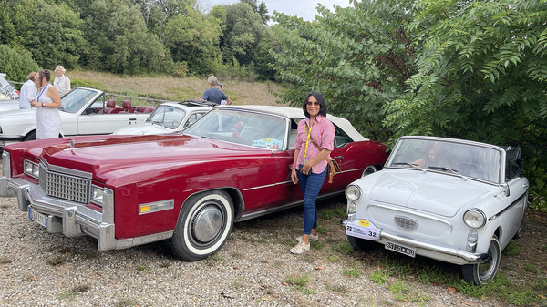 Maureen between a Cadillac Eldorado and an Autobianchi.